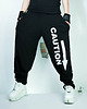 spodnie dresowe damskie Czarne wygodne spodnie unisex CAUTION! 1
